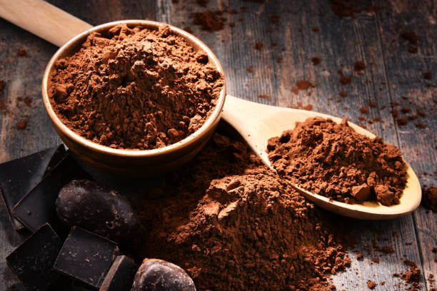 istock Composition with bowl of cocoa powder on wooden table 1093945462