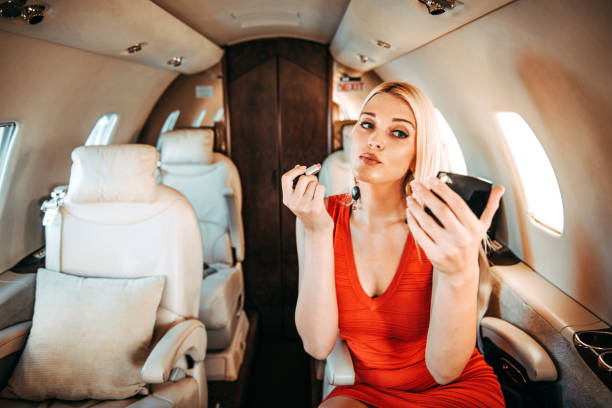 istock Rich businesswoman doing her makeup while traveling aboard a private airplane 1093949604