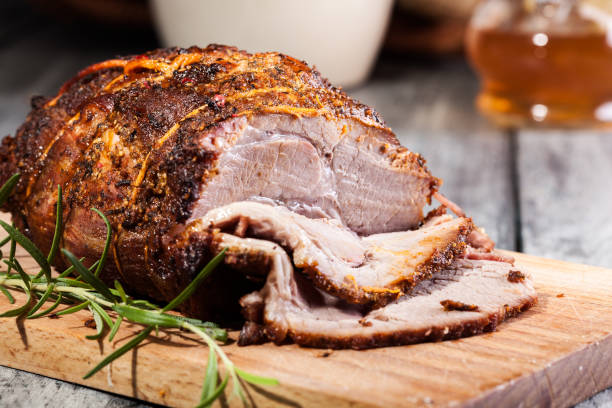 Roasted shoulder of pork Roasted shoulder of pork on a cutting board pork stock pictures, royalty-free photos & images