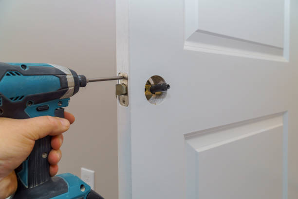 istock Hands repairing a door lock with a screwdriver 1093950796