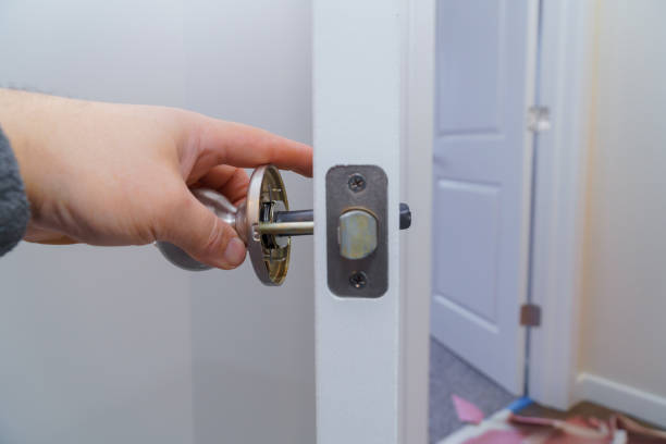 istock Carpenter at lock installation with wood door 1093950808