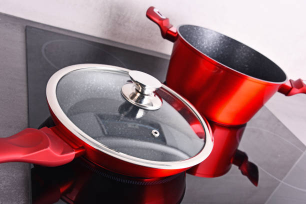 istock Frying pan and steel pot on modern induction cooktop 1093953246