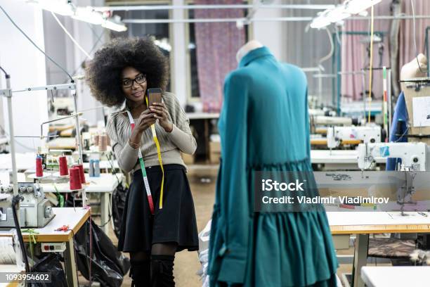Female Designer With Tape Measure Using Phone Stock Photo - Download Image Now - African Ethnicity, Artist, Fashion