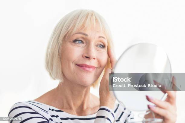 Senior Woman Touching Her Soft Face Skin Stock Photo - Download Image Now - Aging Process, Women, Senior Adult