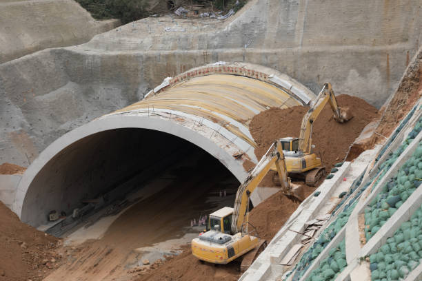 istock Highway tunnel construction site with yellow tractors 1093958240