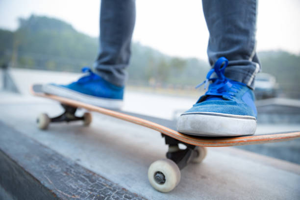 istock skateboarding legs riding skateboard at skatepark 1093958732