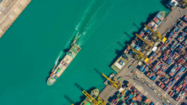 istock Container ship in export and import business logistics and transportation. Cargo and container box shipping to harbor by crane. Water transport International. Aerial view and top view. 1093965472