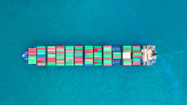 istock Container ship in export and import business logistics and transportation. Cargo and container box shipping to harbor by crane. Water transport International. Aerial view and top view. 1093965476