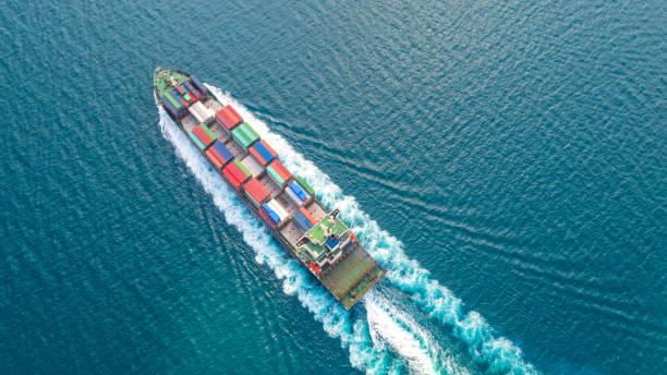 istock Container ship in export and import business logistics and transportation. Cargo and container box shipping to harbor by crane. Water transport International. Aerial view and top view. 1093965494