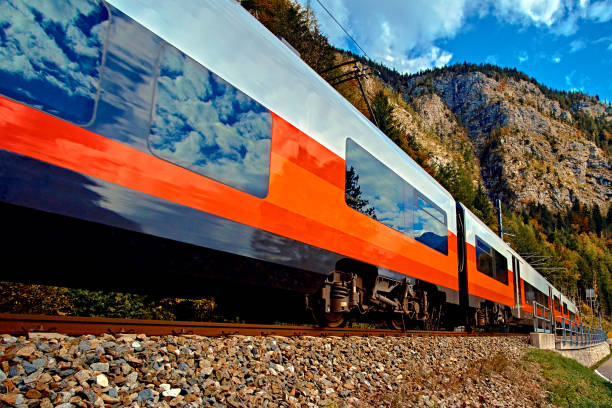 istock Red blue train in motion in Austrian alps mountains. High speed mountain train arrives at Hallstatt Obertraun train station in mountains. Location: resort village Hallstatt, Salzkammergut, Austria 1093966032