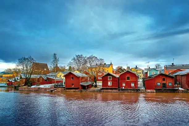 Old historic Porvoo, Finland with wooden houses and medieval stone and brick Porvoo Cathedral at blue hour sunrise.