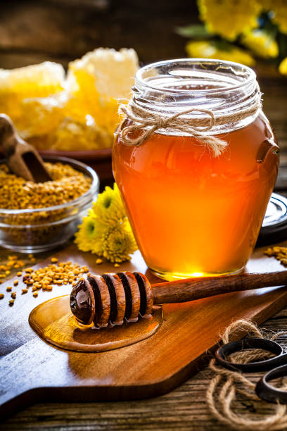 istock Honey jar, bee pollen and honeycomb on rustic wooden table 1093966712