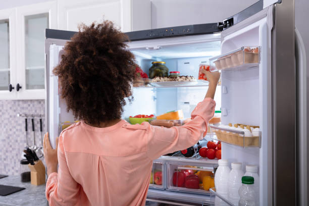 istock Woman Taking Food From Refrigerator 1093971890