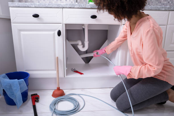 istock Woman Cleaning Clogged Sink Pipe 1093971994