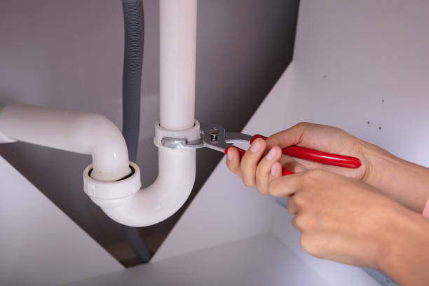 istock Woman Repairing Sink Pipe With Adjustable Wrench 1093972012