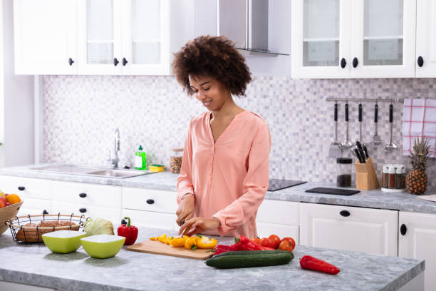 istock Smiling Woman Cutting Vegetables On Chopping Board 1093972106