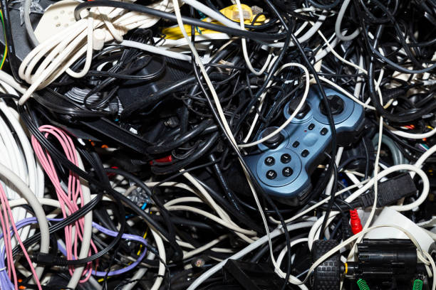 Entangled heap of electronic scrap Close-up of an entangled heap of electronic scrap including a game console controller waiting for recycling recycling computer electrical equipment obsolete stock pictures, royalty-free photos & images
