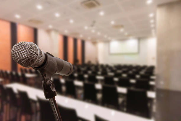 istock Microphone over the blurred business forum Meeting or Conference Training Learning Coaching Room Concept, Blurred background. 1093972910