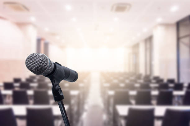 istock Microphone over the blurred business forum Meeting or Conference Training Learning Coaching Room Concept, Blurred background. 1093972930