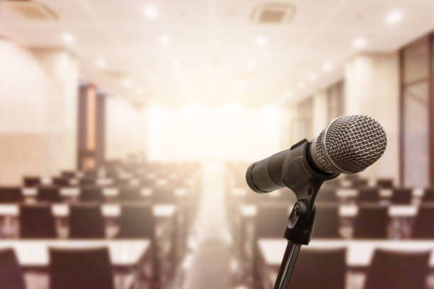 istock Microphone over the blurred business forum Meeting or Conference Training Learning Coaching Room Concept, Blurred background. 1093972934