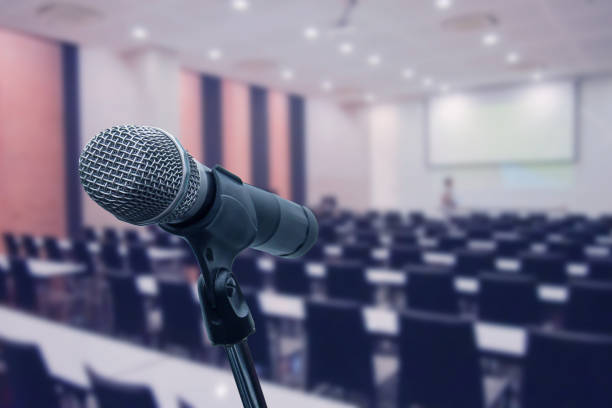 istock Microphone over the blurred business forum Meeting or Conference Training Learning Coaching Room Concept, Blurred background. 1093972952