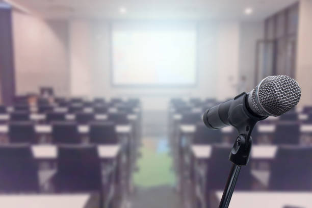 istock Microphone over the blurred business forum Meeting or Conference Training Learning Coaching Room Concept, Blurred background. 1093974108