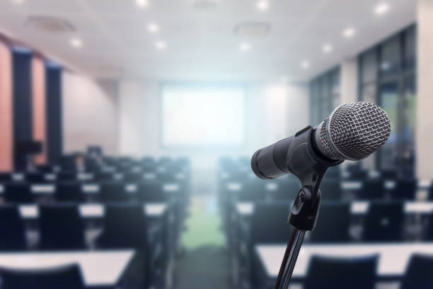 istock Microphone over the blurred business forum Meeting or Conference Training Learning Coaching Room Concept, Blurred background. 1093974136