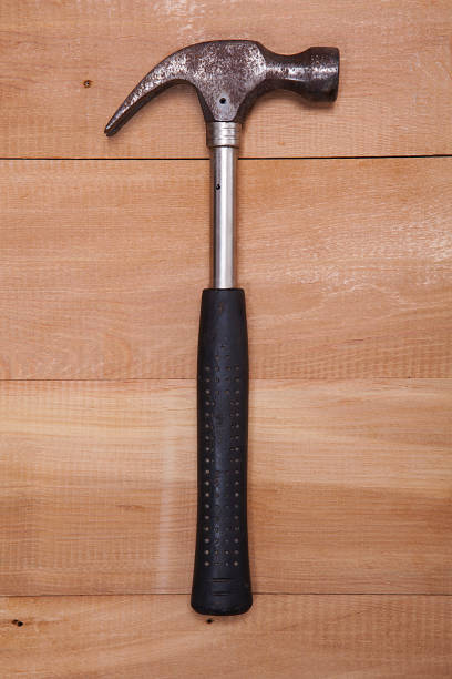 istock Hammer on wooden table background. 1093974176