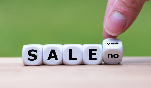 istock On sale? Hand turns a dice and changes the word 