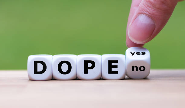 istock Taking drugs? Hand flips a dice and changes the word 
