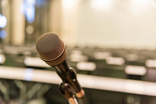 istock Microphone over the blurred business forum Meeting or Conference Training Learning Coaching Room Concept, Blurred background. 1093974316