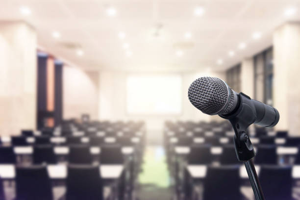 istock Microphone over the blurred business forum Meeting or Conference Training Learning Coaching Room Concept, Blurred background. 1093974324