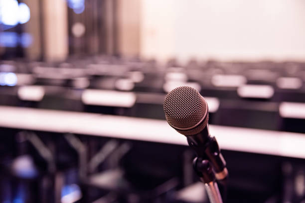 istock Microphone over the blurred business forum Meeting or Conference Training Learning Coaching Room Concept, Blurred background. 1093974388