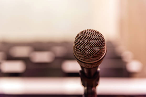 istock Microphone over the blurred business forum Meeting or Conference Training Learning Coaching Room Concept, Blurred background. 1093974440