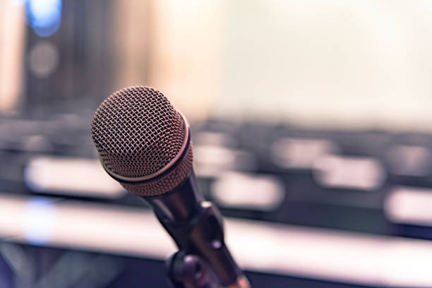 istock Microphone over the blurred business forum Meeting or Conference Training Learning Coaching Room Concept, Blurred background. 1093974460