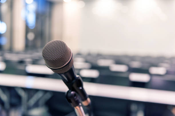 istock Microphone over the blurred business forum Meeting or Conference Training Learning Coaching Room Concept, Blurred background. 1093974480