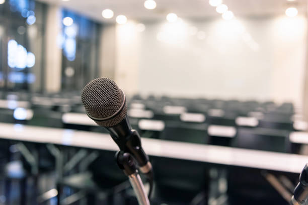 istock Microphone over the blurred business forum Meeting or Conference Training Learning Coaching Room Concept, Blurred background. 1093974490