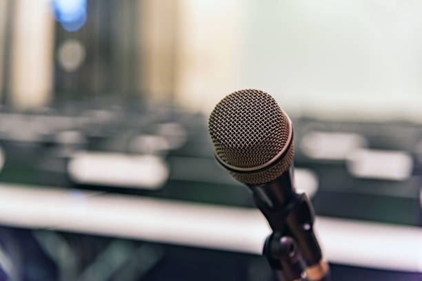 istock Microphone over the blurred business forum Meeting or Conference Training Learning Coaching Room Concept, Blurred background. 1093974494