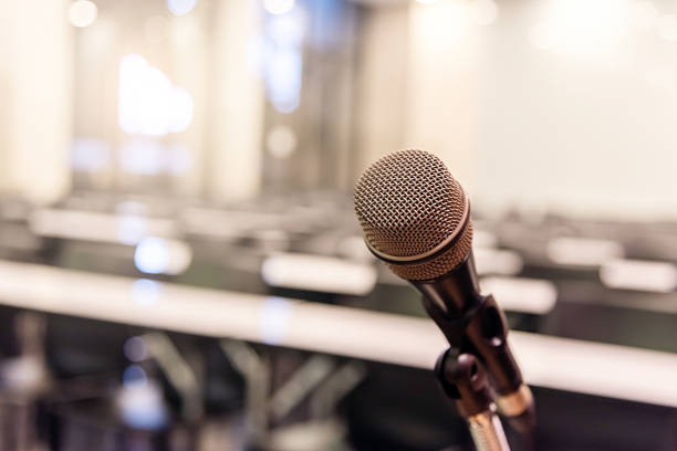 istock Microphone over the blurred business forum Meeting or Conference Training Learning Coaching Room Concept, Blurred background. 1093974592