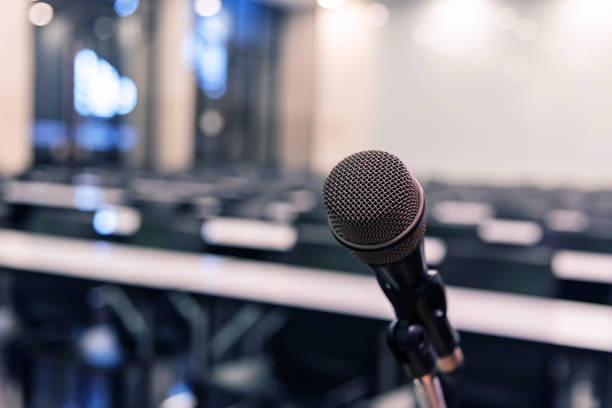 istock Microphone over the blurred business forum Meeting or Conference Training Learning Coaching Room Concept, Blurred background. 1093974622
