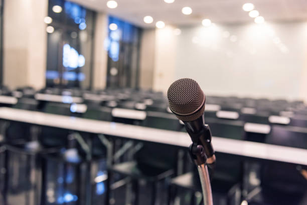 istock Microphone over the blurred business forum Meeting or Conference Training Learning Coaching Room Concept, Blurred background. 1093974650