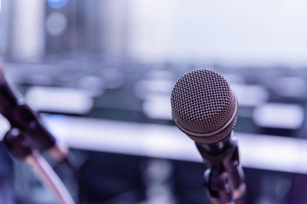 istock Microphone over the blurred business forum Meeting or Conference Training Learning Coaching Room Concept, Blurred background. 1093974728
