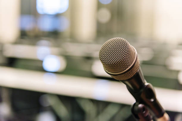 istock Microphone over the blurred business forum Meeting or Conference Training Learning Coaching Room Concept, Blurred background. 1093974748