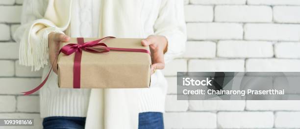 Close Up Young Woman Wear White Color Sweater In Winter Season And Hand Holding Special Present With Red Tied Bow For Give To Someone In Valentines Day Birthday Xmas New Year Festival Celebration Concept Stock Photo - Download Image Now