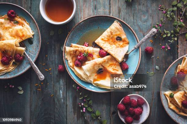 Pancake Suzette Citrus Sauce And Rum And Raspberries For Candlemas Stock Photo - Download Image Now