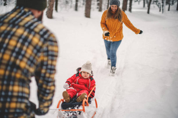 istock Young happy family sledding 1093989488