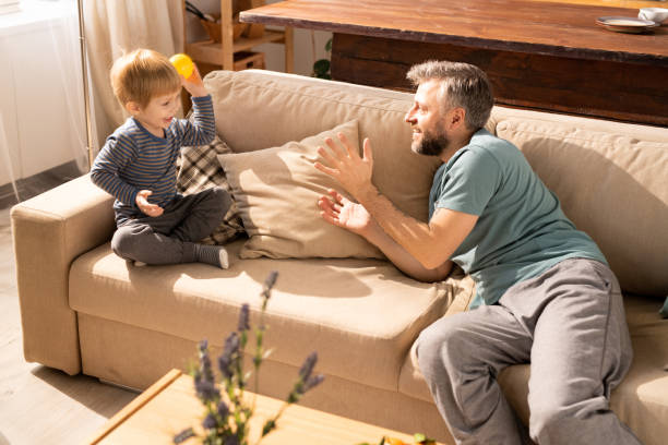istock Father catching toy ball thrown by son 1093991494