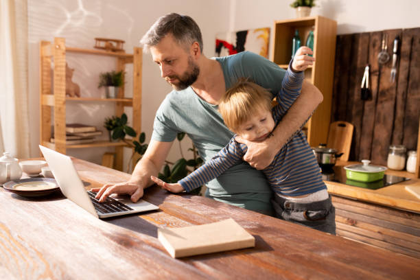 Modern father trying to work and look after son