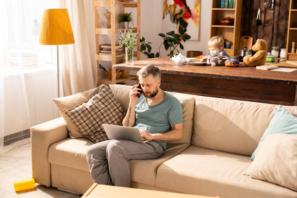 istock Busy father working at home while son being bored 1093991542