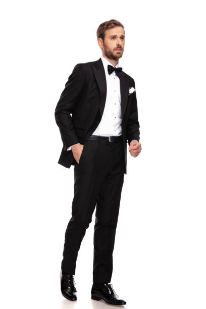 istock curious businessman in black suit looks to side while walking 1093992032